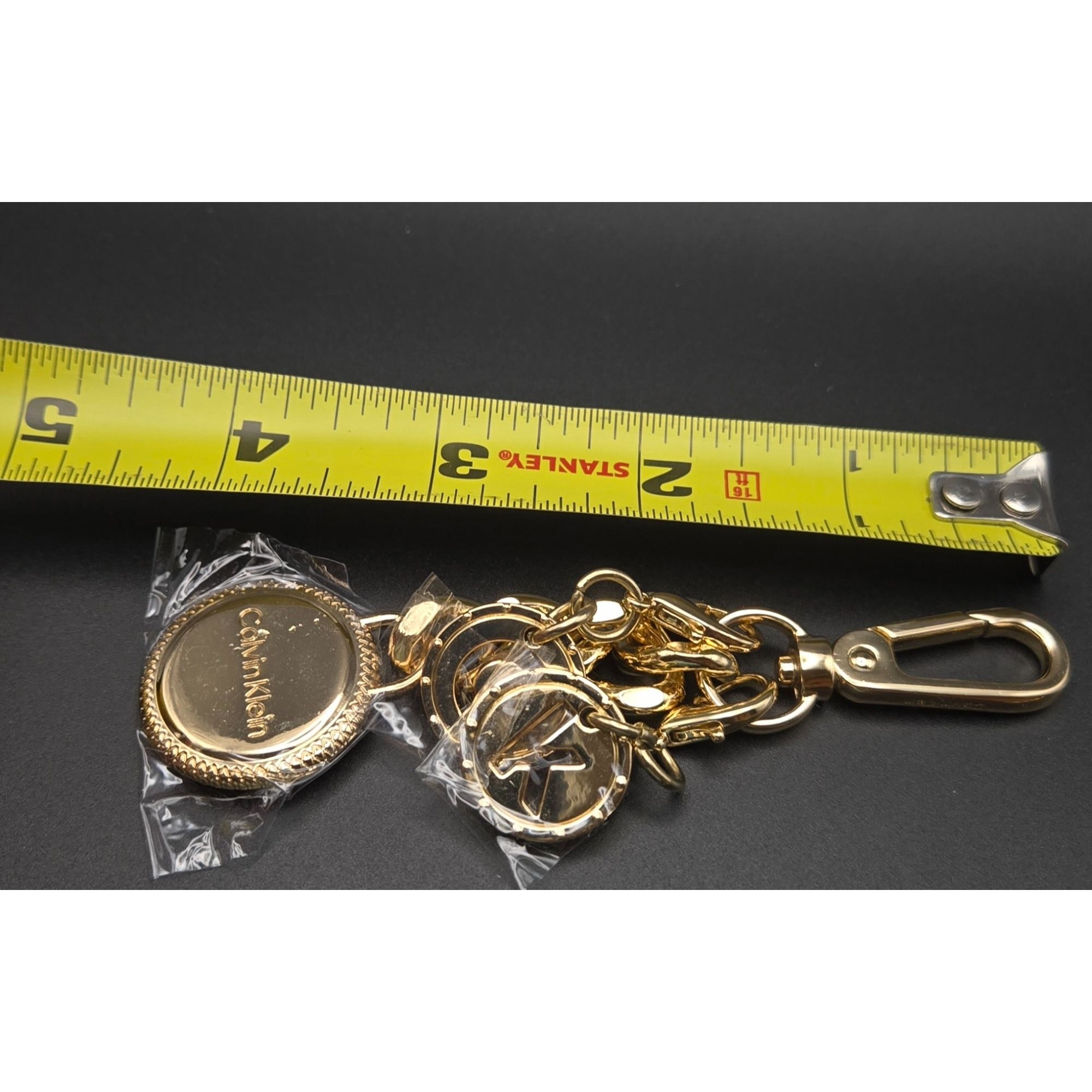Calvin Klein Gold-Tone Logo Keychain purse charm With Decorative Charms & Lobster Clasp 4"